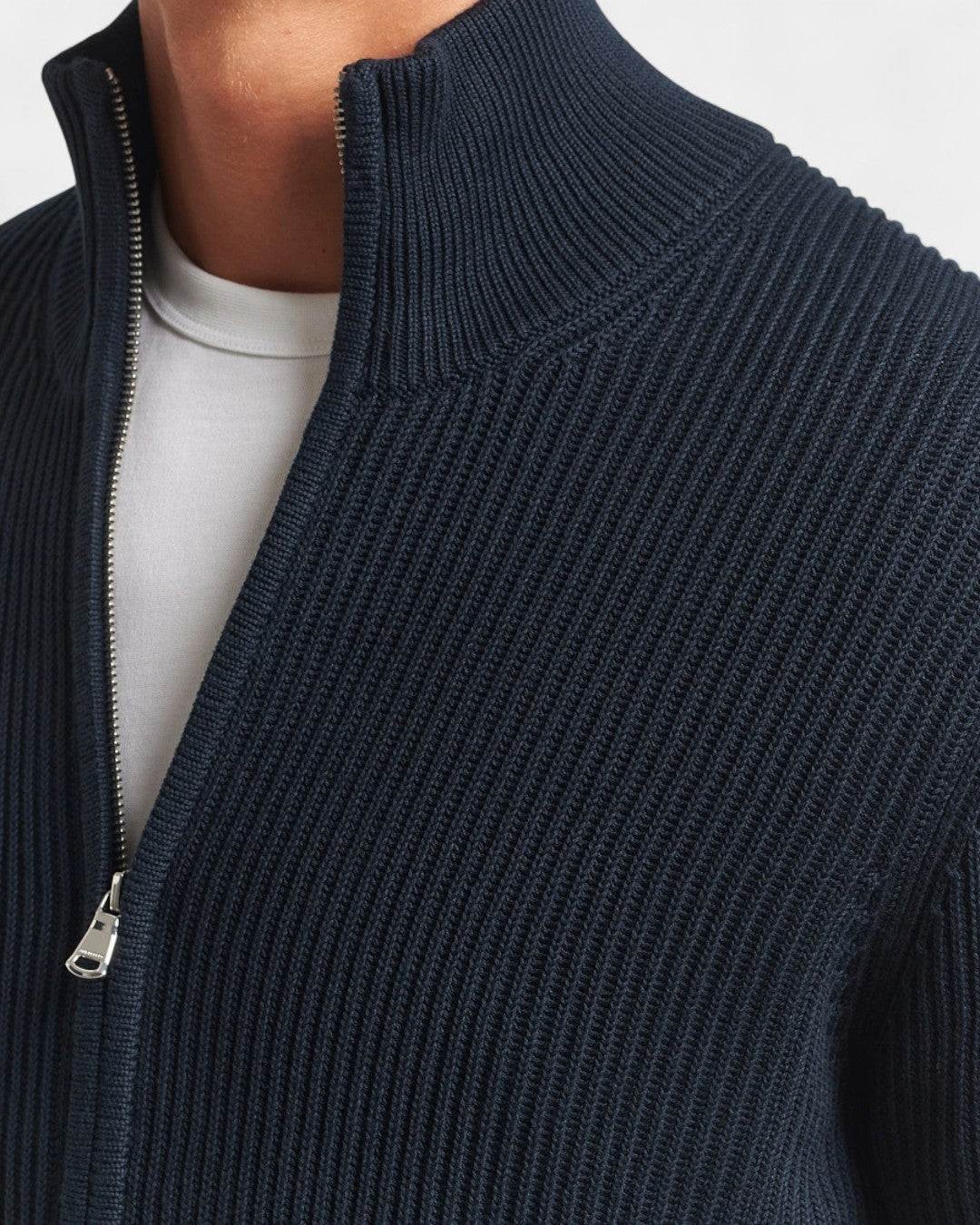 Close-up of Montclair Knitted Zip Ribbed Cardigan in black showing ribbed texture and zipper detail